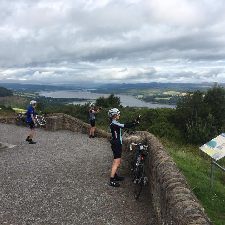 people taking photo of a view in scotland