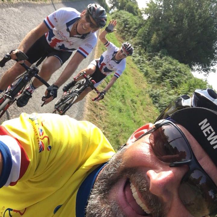 cyclists waving whilst on bike