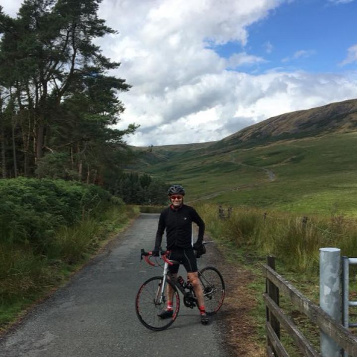 cyclist with hill climb in background