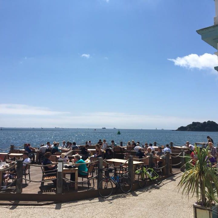 people eating outside on Plymouth Harbour