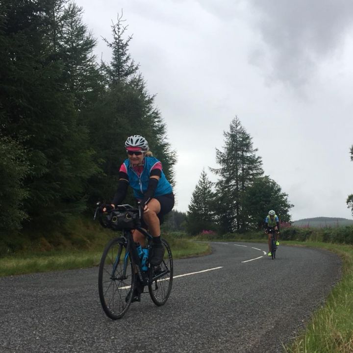 two ladies cycling on road