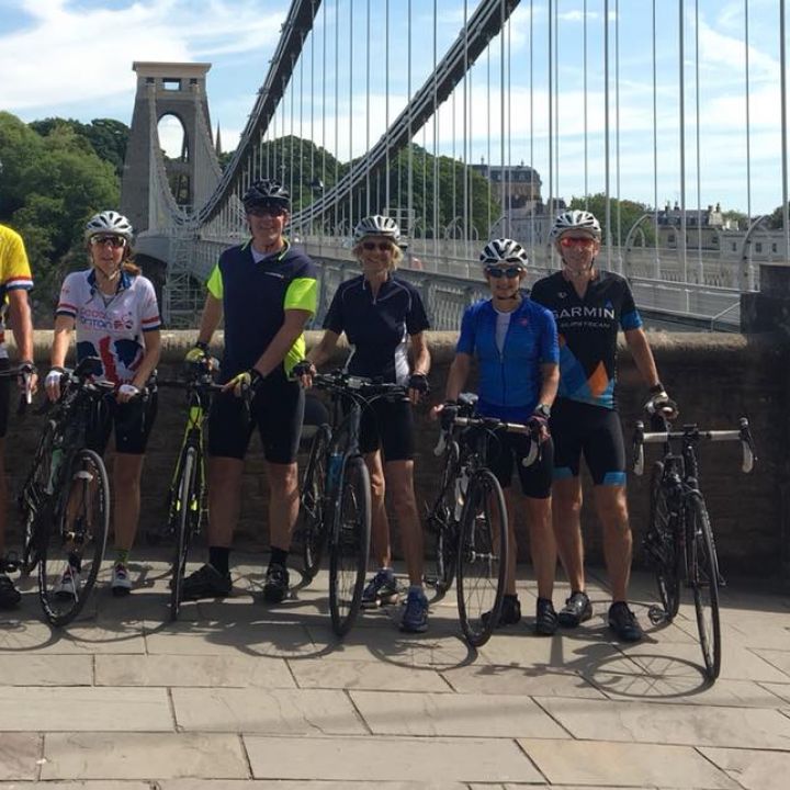 cyclists posing at bridge