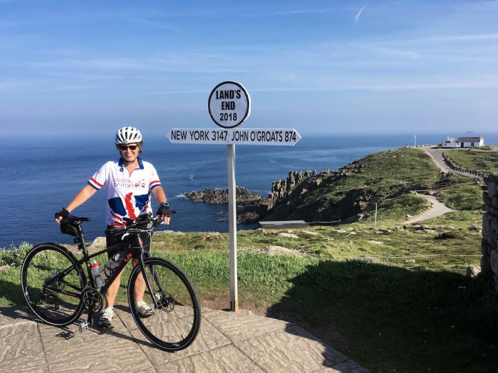 picture of lady with bike at lands end